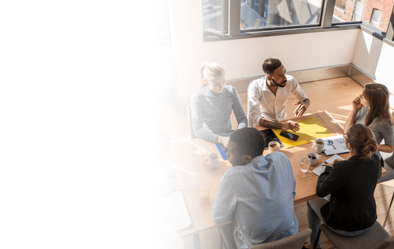 A team in an alignment workshop, gathered around a table