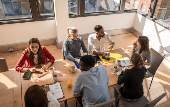 A team in an alignment workshop, gathered around a table